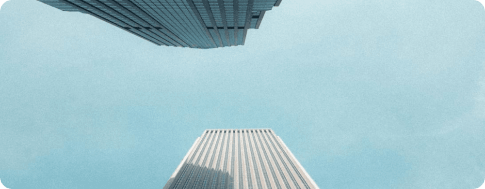 Office towers viewed from street level against a clear sky