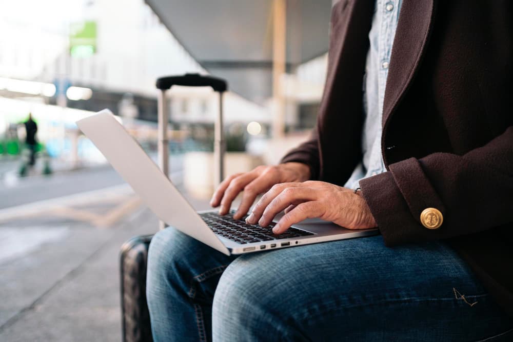 Traveler using a laptop hotspot while waiting at the airport