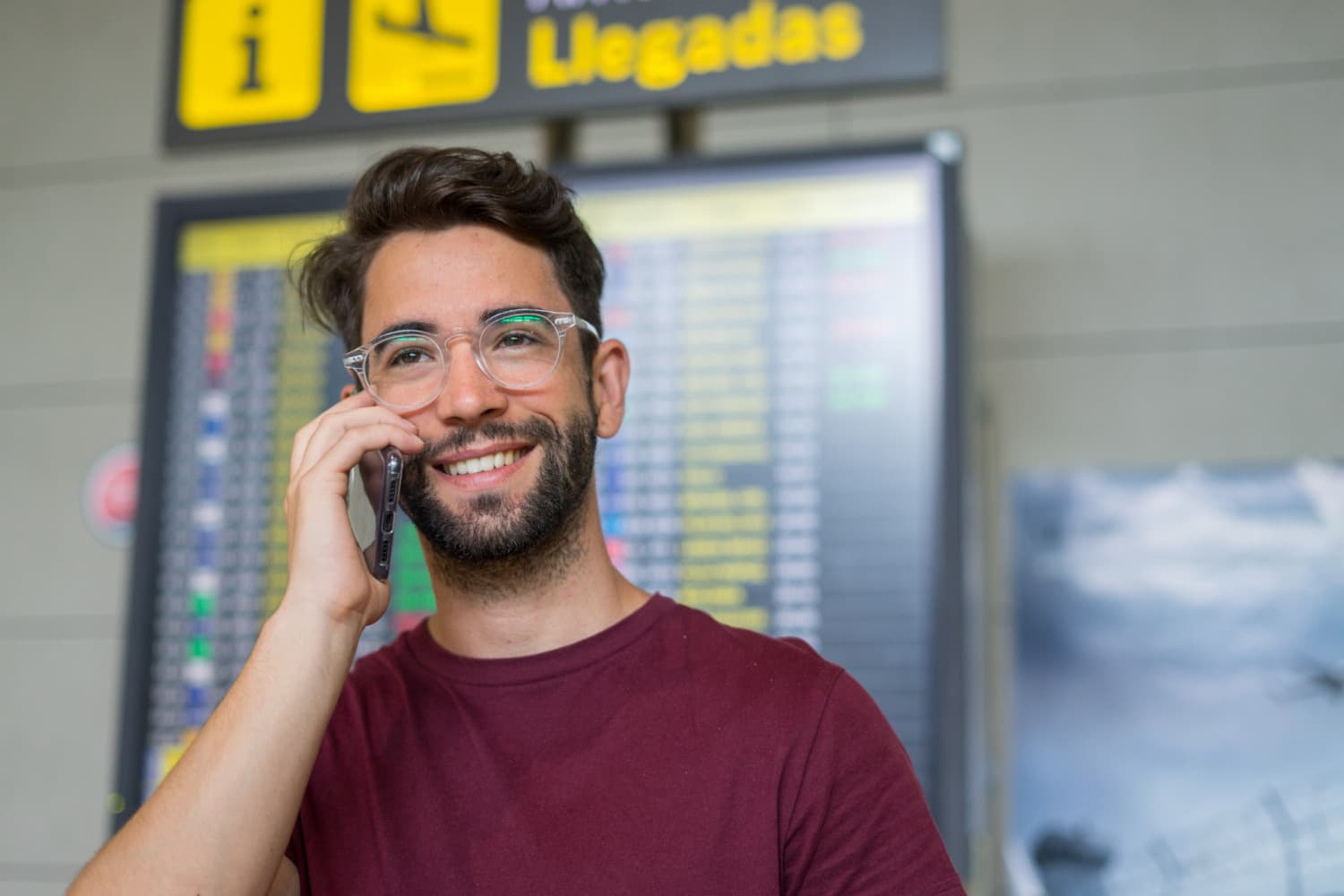 man at the airport making really cheap international calls in his mobile phone using Firsty