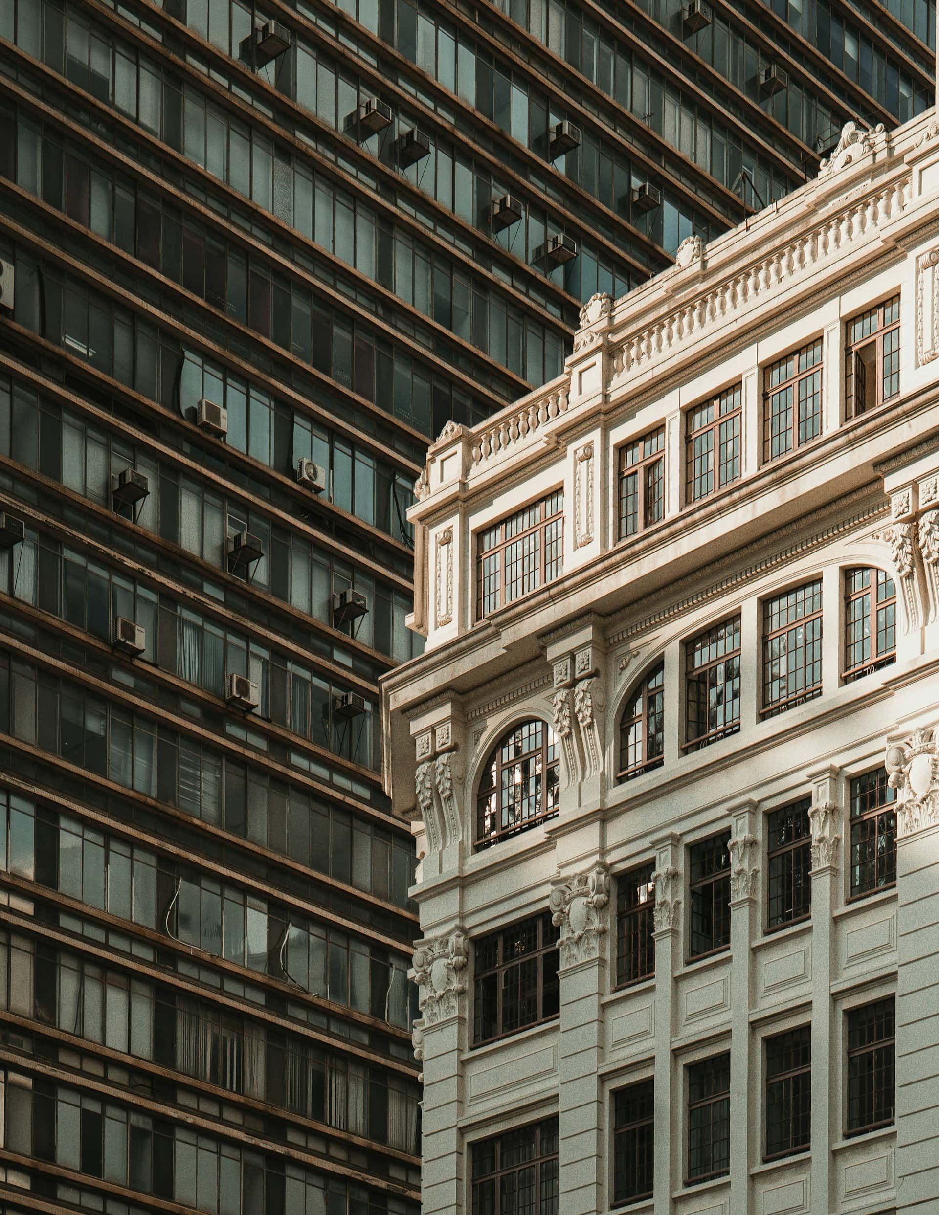 Ornate stone building beside a modern glass office tower