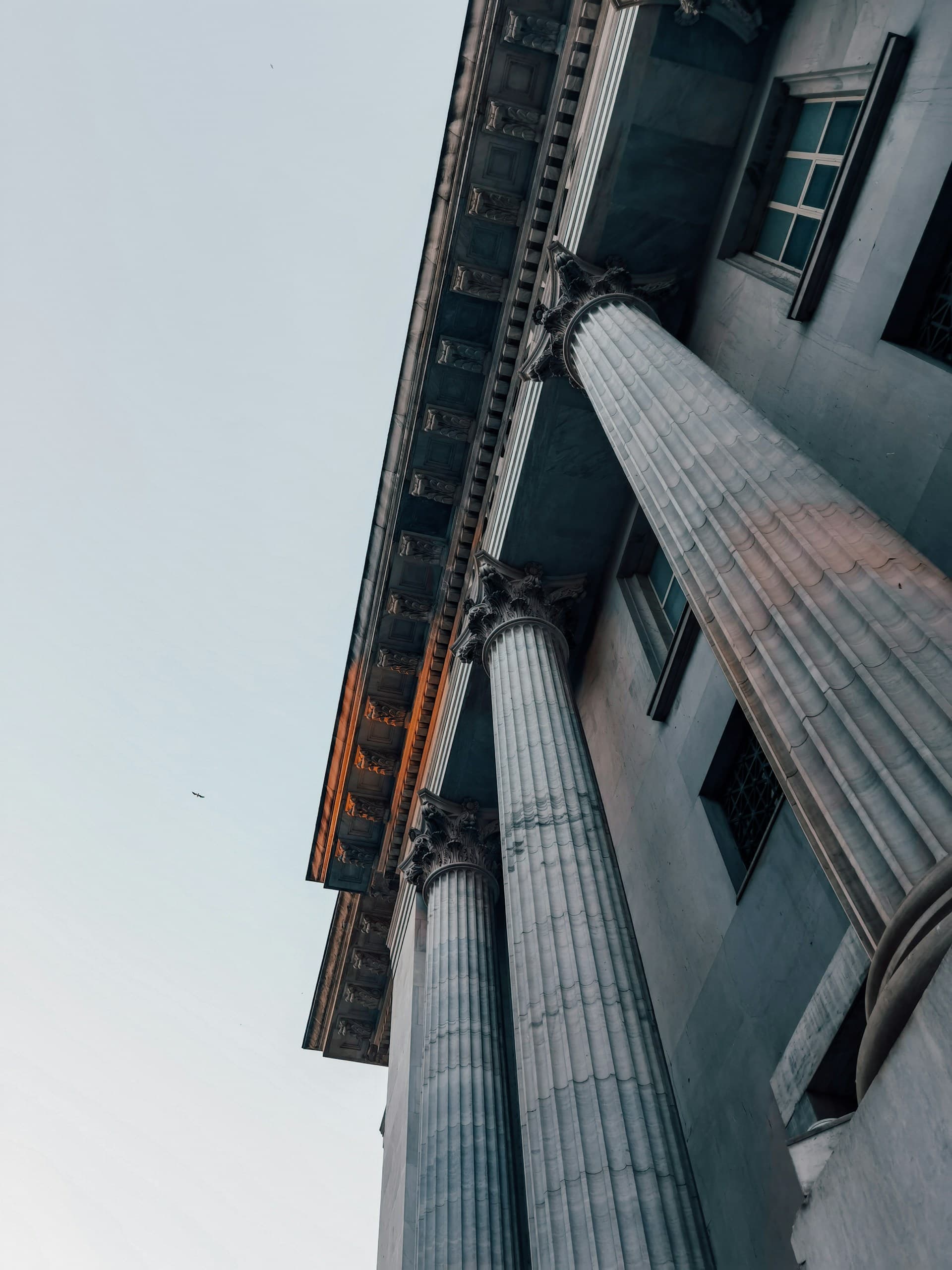 Corinthian columns of a classical bank building seen from below