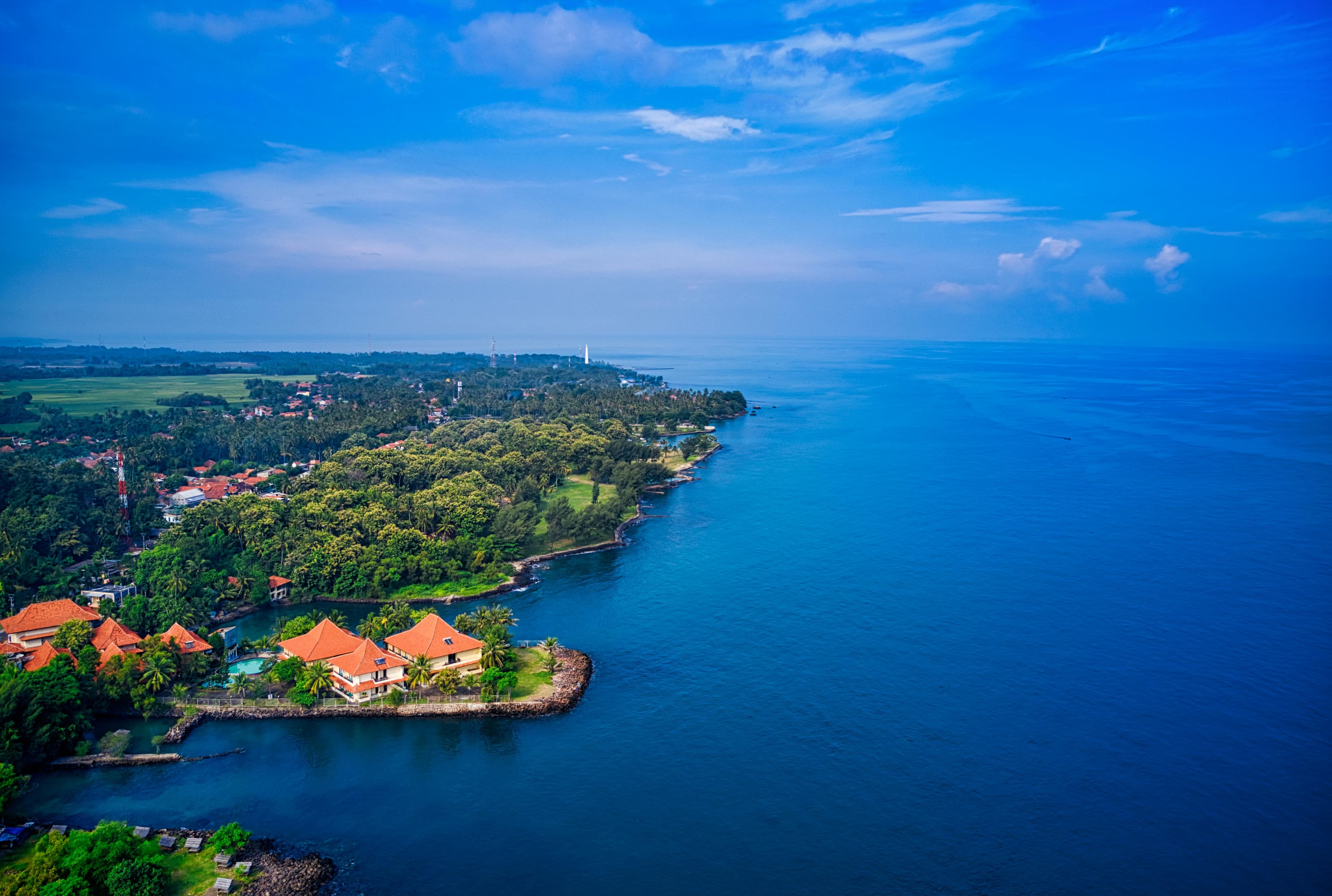 Aerial view of a tropical coastline with a beachfront resort