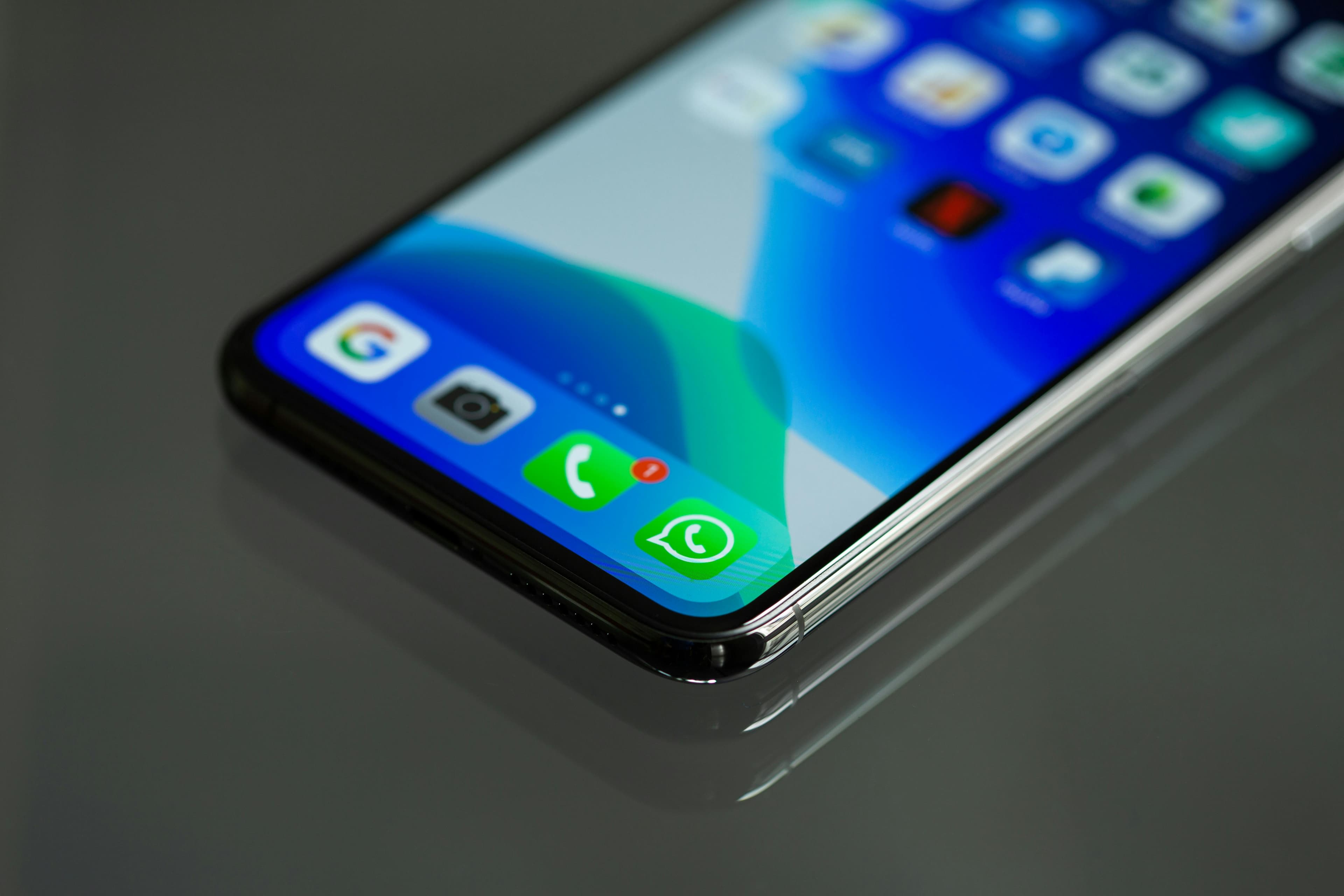 Phone home screen with the WhatsApp icon highlighted