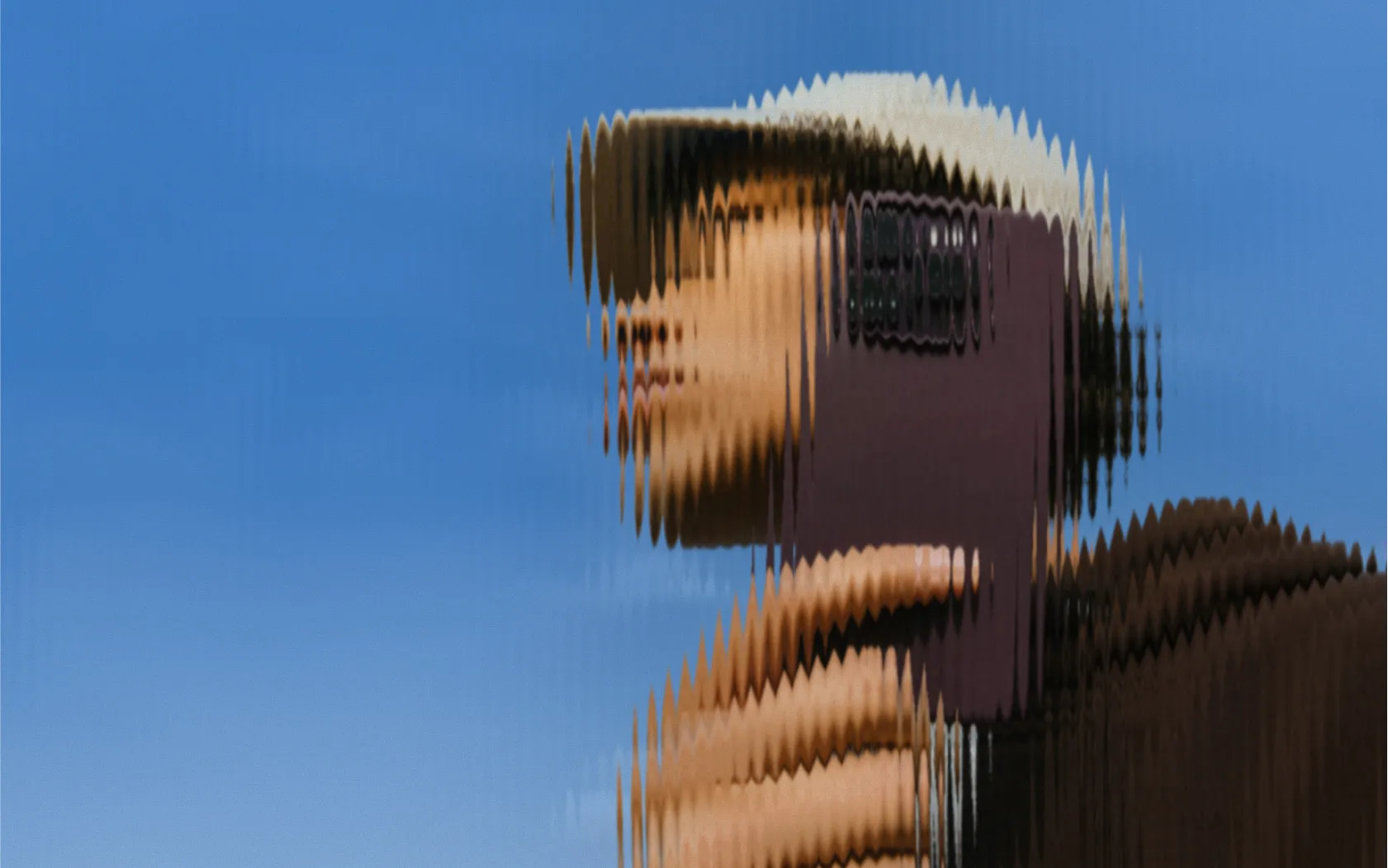 Person outdoors with their phone, blue sky